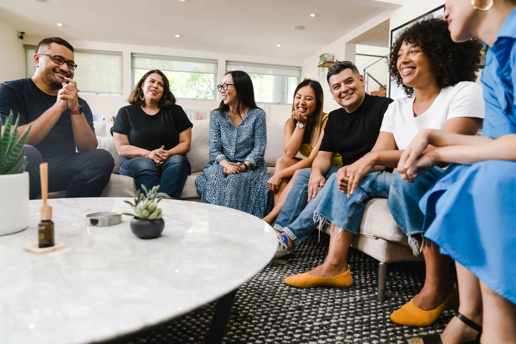 A micro church gathered around a coffee table in a home